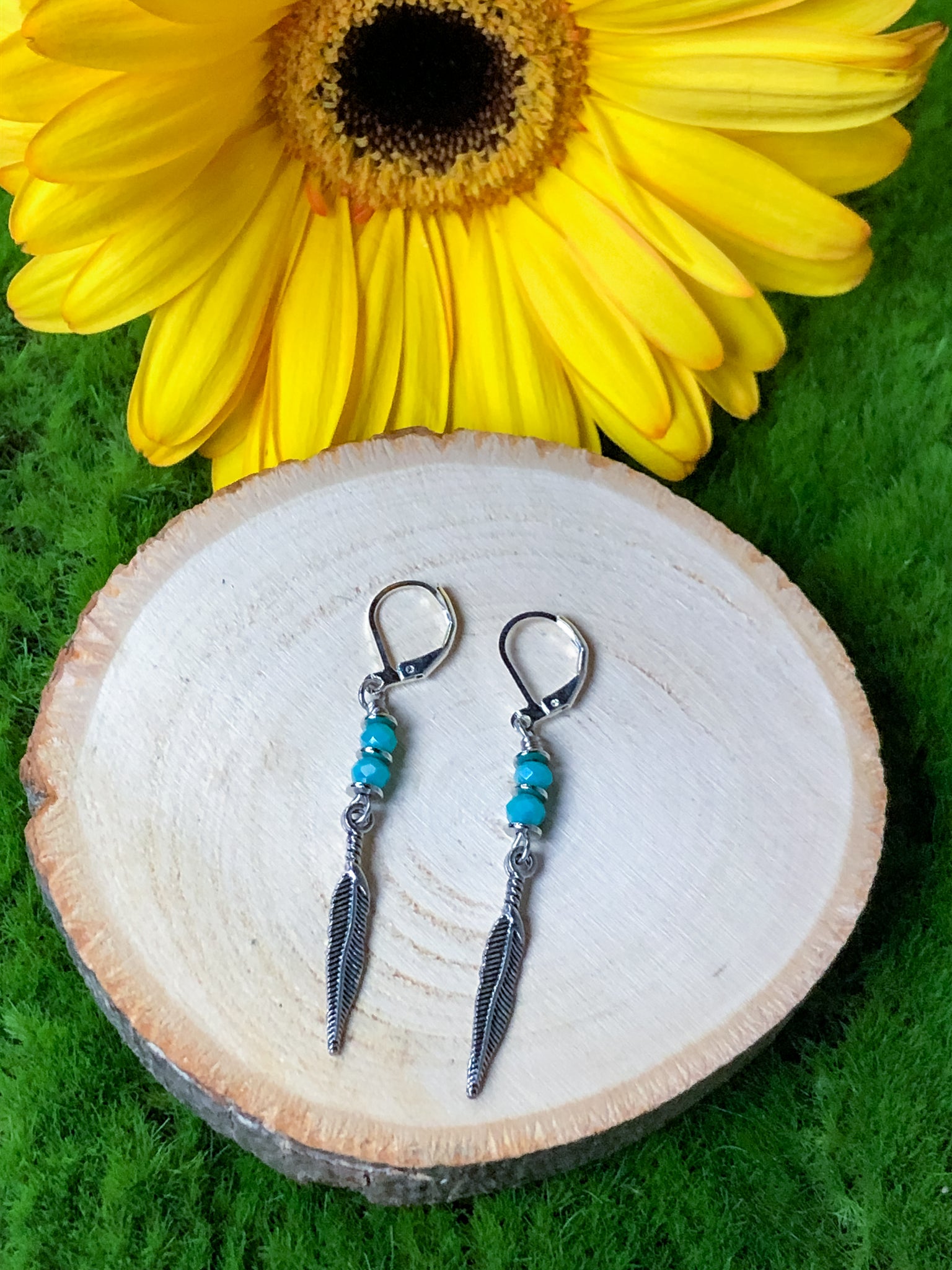 Feather earrings, blue beads